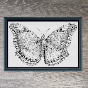 May include: Black and white cross stitch pattern of a butterfly on a woodgrain background. The pattern is titled "Monochrome Butterfly" and measures 255 x 161 stitches.
