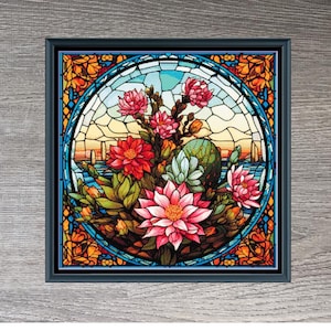 May include: A stained glass style cross stitch pattern featuring a bouquet of Southwestern flowers in shades of pink, red, yellow, and green. The pattern is framed in a dark wood frame and measures 294 x 293 stitches.