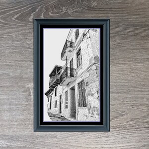 May include: Black and white cross-stitch pattern of a narrow street in a European city. The pattern is framed in a black frame and is titled "Old World Side Street" with the dimensions 268 x 450.