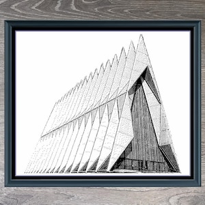 May include: A black and white line drawing of the Air Force Academy Chapel, a modern architectural masterpiece with a distinctive triangular design. The image is framed in a black frame and set against a woodgrain background. The text "Air Force Academy Chapel" and "480 x 425" are printed below the image.