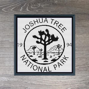 May include: Black and white illustration of a Joshua Tree National Park logo with a Joshua tree and mountains. The text "Joshua Tree National Park" is in a circle around the image. The text "19" and "94" are on either side of the circle. The image is on a woodgrain background. The text "Joshua Tree Monochrome" and "200 X 200" are below the image.