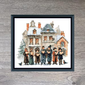 May include: Framed cross-stitch art titled "Village Carolers" featuring a winter scene with carolers in front of snow-covered buildings. The artwork is in a black frame and measures 160 x 140 inches.