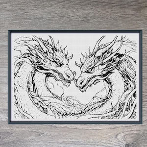May include: Framed black and white artwork depicting two dragons facing each other. The dragons are detailed with a pen and ink style. The artwork is set against a light wood grain background. The text "Stitching Jules Design" is at the top.