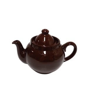 May include: A glossy dark brown teapot with a rounded body, a curved spout, a matching lid with a small knob handle, and a C-shaped handle. The teapot features a smooth, reflective surface and a classic, simple design for brewing tea.
