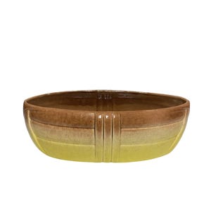 May include: An oval ceramic bowl with a gradient colour scheme. The bowl transitions from a dark brown at the top to a yellow at the bottom. Vertical lines are present on the sides.