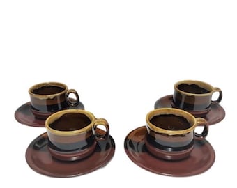 May include: Set of four brown and yellow striped ceramic coffee cups and saucers.