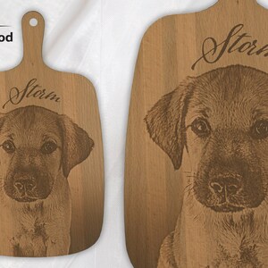 May include: A small wooden chopping board with a brown dog engraved on it. The dog's name, "Storm", is engraved above the dog's image.