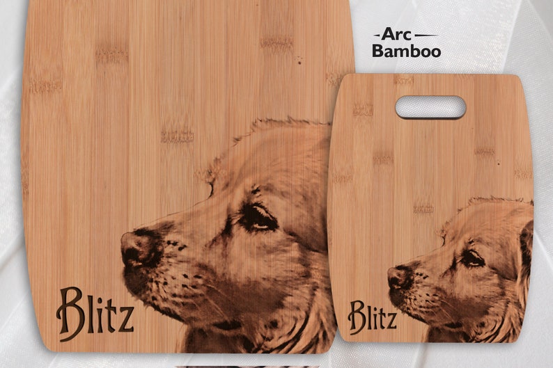 May include: Two wooden chopping boards with a laser engraved image of a dog. The larger board has the name "Blitz" engraved on it. The smaller board has a handle and the name "Blitz" engraved on it.