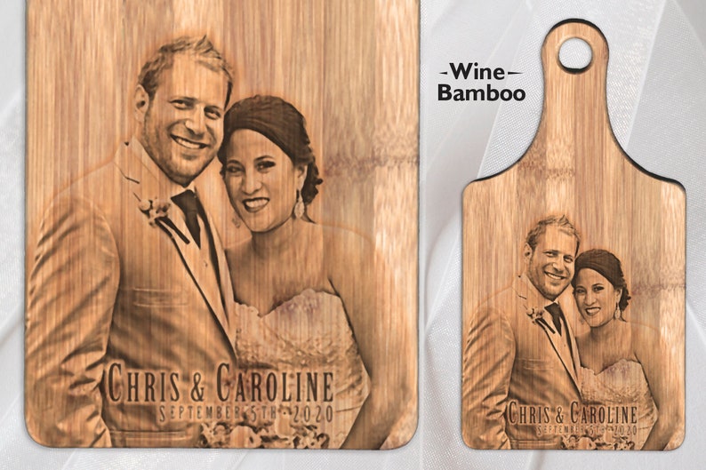 May include: A personalised bamboo chopping board with a laser-engraved photo of a couple. The board has a handle and the text "Chris & Caroline September 5th 2020" is engraved below the photo.