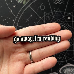 May include: A set of three ceramic mugs with a speckled, matte finish. The mugs are in shades of cream, light gray, and dark gray. Each mug has a simple, minimalist design and a rounded handle.