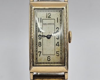 Rare Vintage Hallmark Art Deco tank Watch. 1940's Gold tone curved case, running, great gift or for collectors