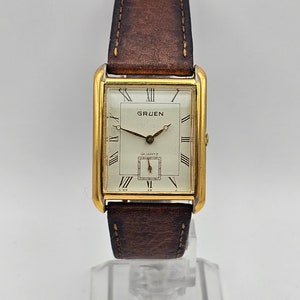 Beautiful Vintage GRUEN Men's Gold tone curved Tank Watch, Roman Numerals, Sub second dial hand, Japan movement, brown band, New battery