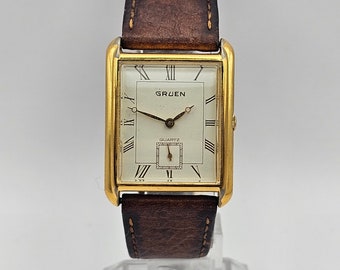 Beautiful Vintage GRUEN Men's Gold tone curved Tank Watch, Roman Numerals, Sub second dial hand, Japan movement, brown band, New battery
