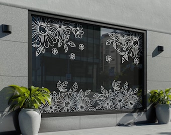May include: A large rectangular window featuring white line art floral decals. The design includes clusters of daisies and leaves arranged in the top left and bottom sections of the glass. The window is set into a gray stone wall with two potted plants.