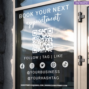 May include: A clear glass window displays white vinyl lettering that reads "BOOK YOUR NEXT appointment" and a QR code. Below are social media icons and handles. The text "vinyl decal for window & wall decor" is at the top.