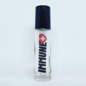 May include: A clear glass roller bottle with a black cap. The bottle has a white label with the word "IMMUNE" in black letters and a red heart with a white plus sign inside.
