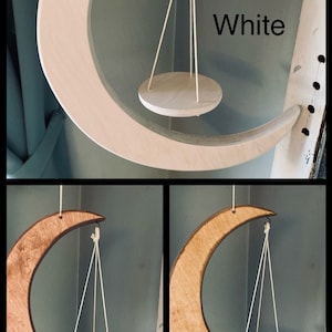 May include: Three crescent moon shaped wooden shelves with hanging plant pots. The shelves are shown in three different wood stains: white, cherry, and golden oak.