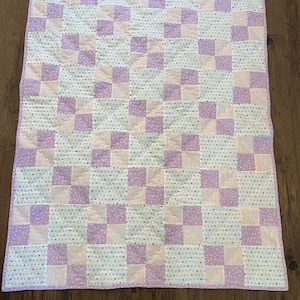 Pink and Purple Hearts are the stars in this cute quilt with companion pink and purple prints. Perfect for all ages and so soft!