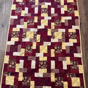 Texas State Bobcats will want this beautiful quilt! It features bobcat fabric with burgundy and gold accent fabric. Great gift too!