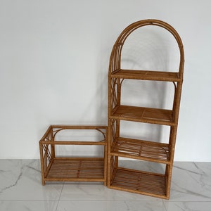 May include: Two brown wicker shelves, one with an arched top and four shelves, the other with two shelves. The shelves are made of woven rattan.