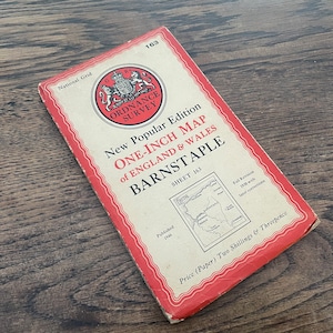 May include: A red and white map of England and Wales, titled "New Popular Edition One-Inch Map of England & Wales Barnstaple Sheet 163". The map is published by the Ordnance Survey and was printed in 1946.
