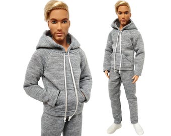 May include: A gray hooded sweatshirt and matching sweatpants. The sweatshirt has a drawstring hood and a kangaroo pocket. The sweatpants have an elastic waistband.