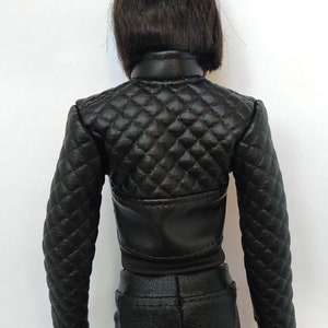 May include: Black quilted leather jacket with a zipper closure. The jacket has a diamond pattern and is cropped at the waist.