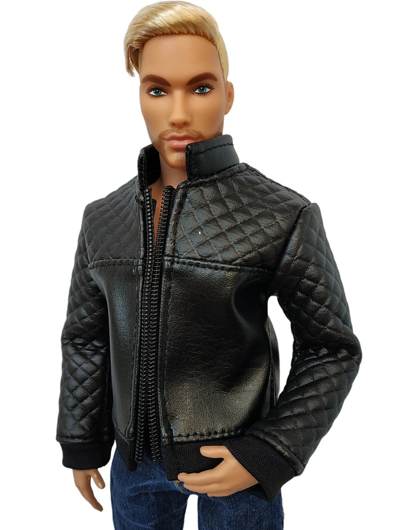 May include: A black quilted jacket with a zipper closure. The jacket has a stand-up collar and a diamond pattern.
