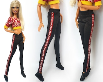 May include: Black leggings with a red stripe down the side. The stripe has the word "NICE" repeated in white.