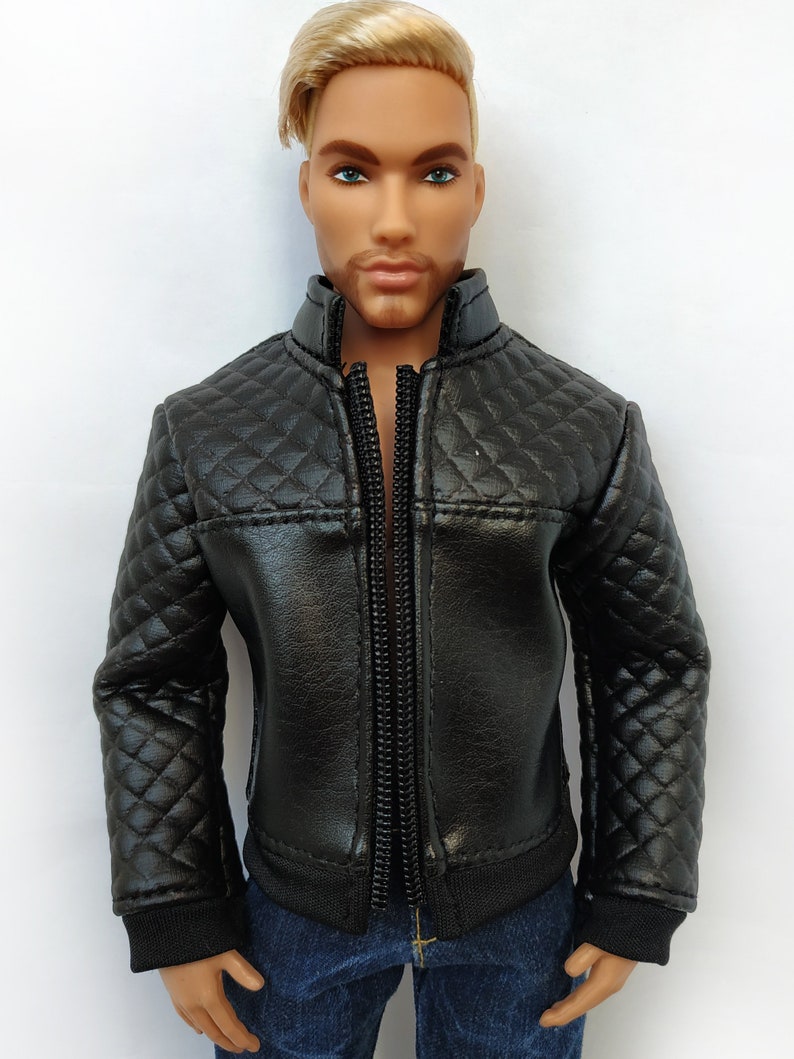 May include: A black quilted leather jacket with a zipper closure. The jacket has a stand-up collar and long sleeves.