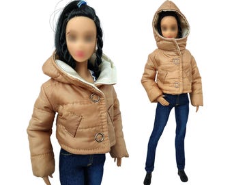 May include: A brown puffer jacket with a faux fur lined hood. The jacket has a zipper closure and two pockets. The jacket is cropped and has a quilted design.