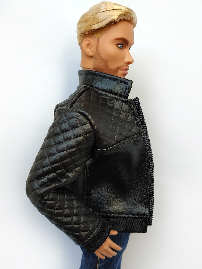 May include: Black quilted leather jacket with a zipper closure. The jacket has a stand-up collar and a ribbed knit cuff.