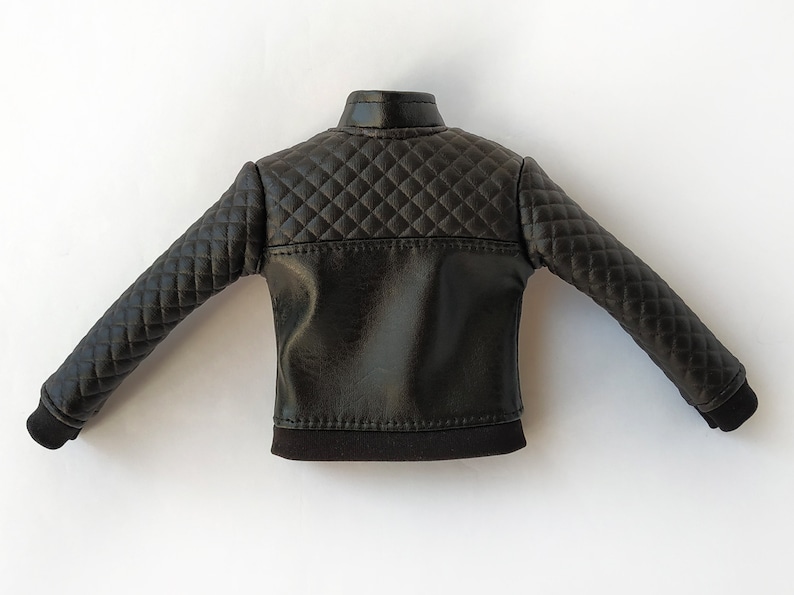 May include: Black quilted leather jacket with a stand-up collar and long sleeves.