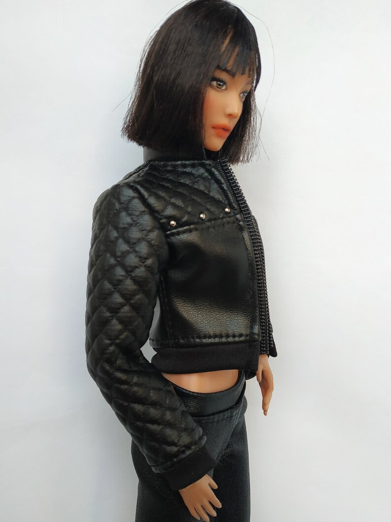 May include: A black quilted leather jacket with a zipper closure and silver studs. The jacket has a cropped style and a black ribbed knit collar.