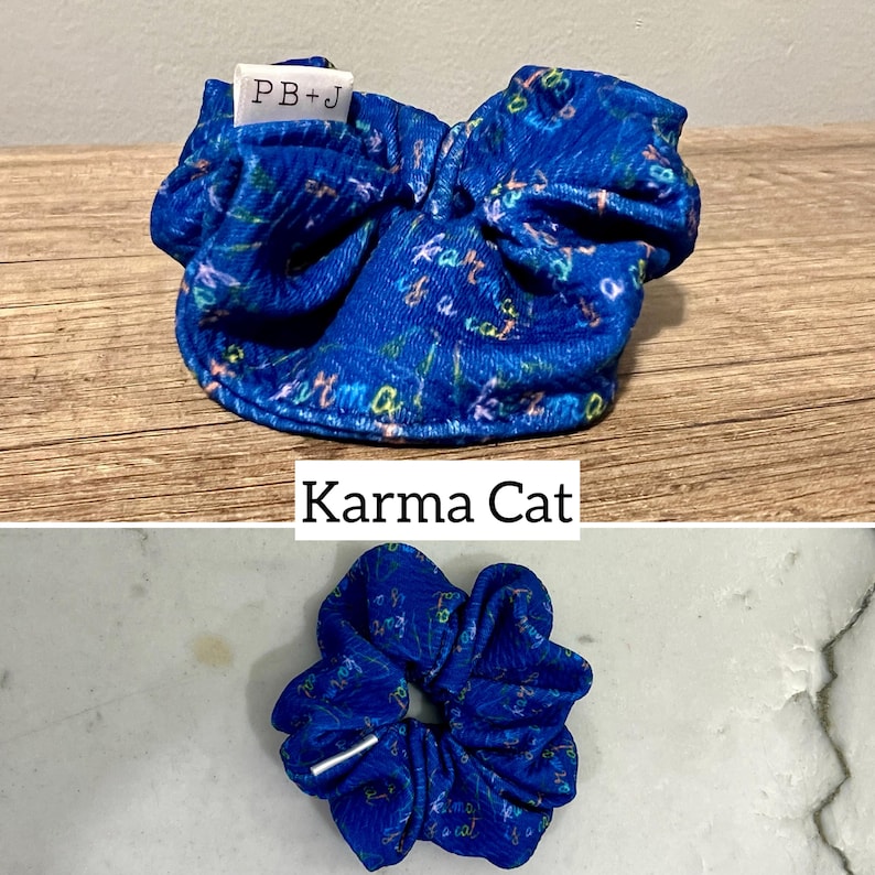 May include: Blue scrunchie with a white label that says "PB+J" and a blue and white pattern with the words "Karma Cat" written on it.