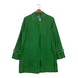 May include: A bright green coat with a classic design, featuring a collar, button closure, and long sleeves. White stitching accents the seams and cuffs. The coat is hanging on a wooden hanger against a white background.