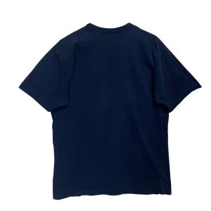May include: A navy blue short-sleeve t-shirt. The shirt has a crew neck and is made of a soft, comfortable material. The t-shirt is a basic wardrobe staple.
