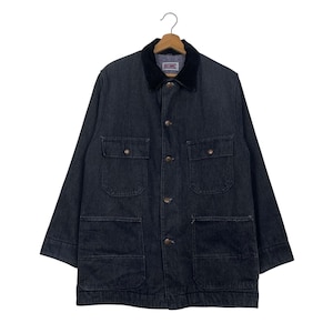 May include: Dark denim jacket with a black corduroy collar. The jacket has four front pockets, button closures, and a relaxed fit. The jacket is hanging on a wooden hanger.
