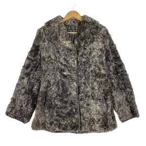 May include: A grey faux fur jacket with a button fastening and a collar. The jacket is hanging on a wooden hanger.