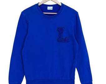 ¡Elige! Sudadera Lacoste de cuello redondo. Sudadera Lacoste con logo pequeño bordado. Sudadera Lacoste de cuello redondo, talla M.
