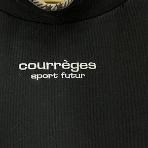 May include: Black ribbed knit top with the white embroidered text "courr&egrave;ges sport futur". The top has a crew neck and a close-up view of the brand's logo. The fabric appears to be a soft, comfortable material.