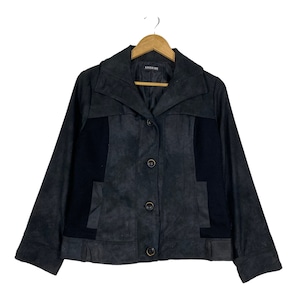 May include: A dark grey suede jacket with black panels and a button fastening. The jacket has a collar and long sleeves. The label "KANGOL KIDS" is visible on the front.