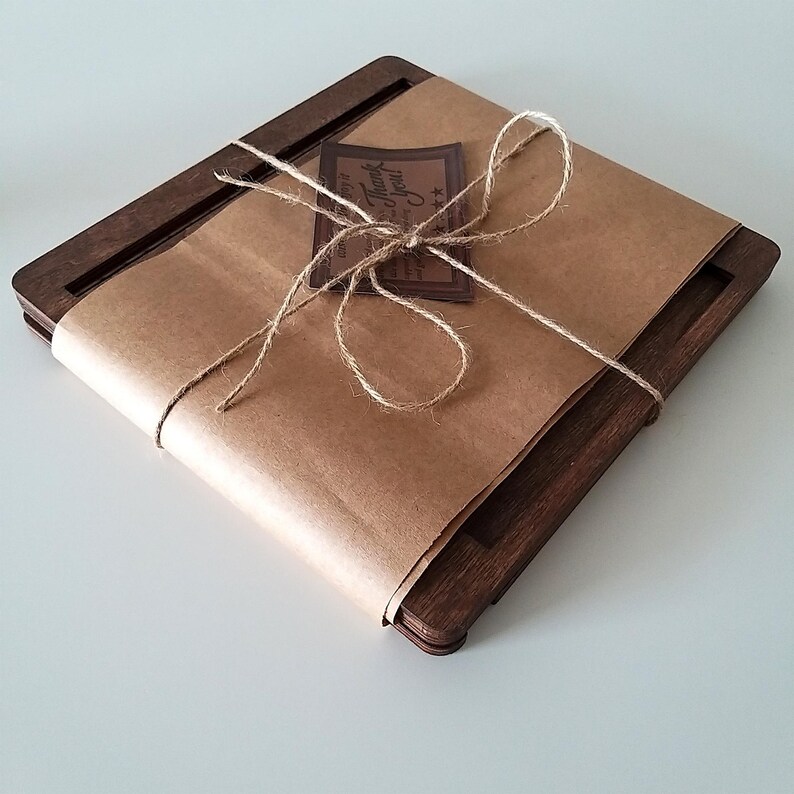 May include: A wooden book stand wrapped in brown paper with twine and a small brown tag that says "Thank You".