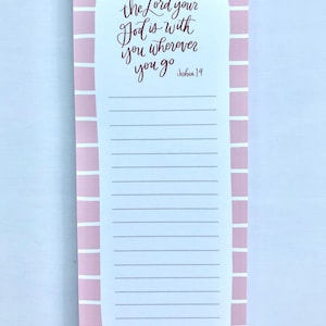 May include: A pink and white notepad with the text "the Lord your God is with you wherever you go Joshua 1:9" in burgundy script. The notepad has a lined section for notes and a pink striped border.