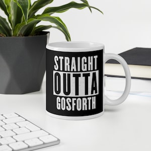 May include: White ceramic mug with the text "STRAIGHT OUTTA GOSFORTH" in a bold, white font against a black background. The mug has a white handle and is sitting on a white surface.