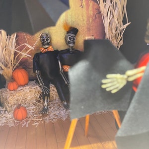 Handmade diorama with scene of skeleton photography studio