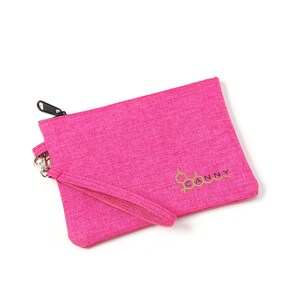 May include: A pink zippered pouch with a black zipper and a gold embroidered logo that says "CANNY".