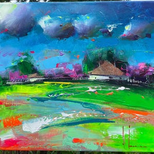May include: Abstract landscape painting with vibrant colors. The artwork features a bright blue sky with dark clouds, a green field, and touches of pink and orange. The painting is on a rectangular canvas.