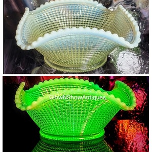 May include: Two images of a decorative glass basket with a woven pattern. The top image is a pale yellow-green, while the bottom image glows bright green. The basket has a ruffled edge and a round base. The text "GlowNShowAntiques" is visible on the bottom image.