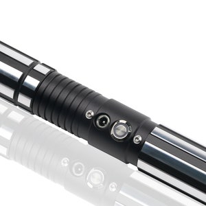 May include: A black and silver lightsaber with a textured grip and a power button and charging port.